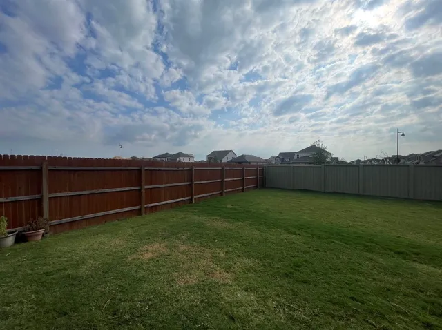 a utility room with wooden floor washer and dryer