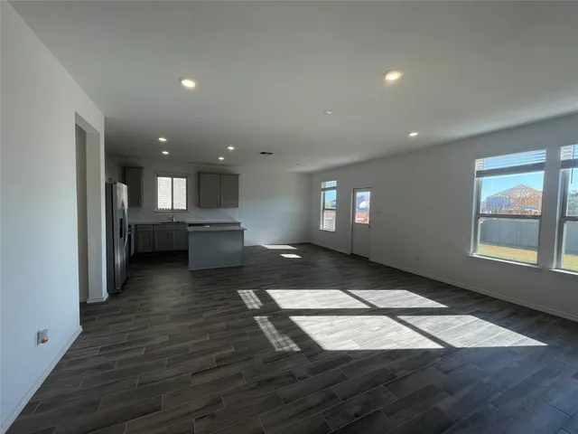 a view of a kitchen with a sink and dishwasher a oven with wooden floor