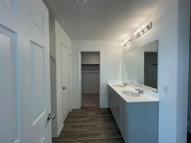 an empty room with a fireplace and windows