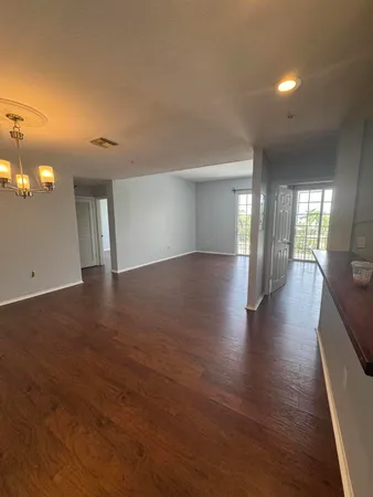 a view of hallway with wooden floor