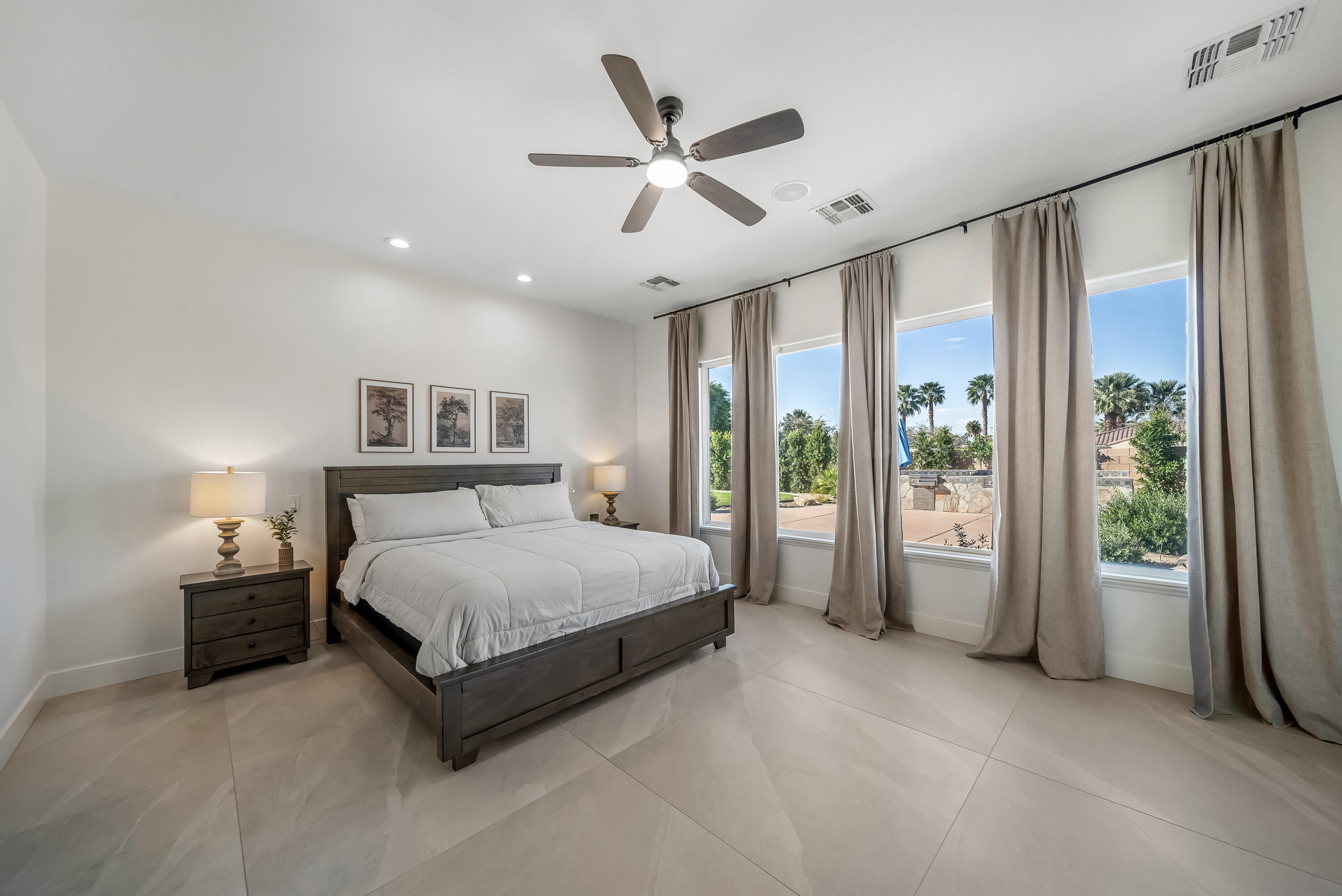 80262 Amazon Avenue Indio, CA 92201 - Photo 45 of 69 a spacious bedroom with a bed and large window