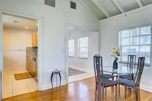 a view of a dining room with furniture and window