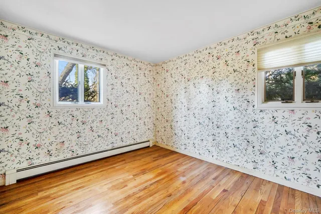 a view of a room with wooden floor and a window