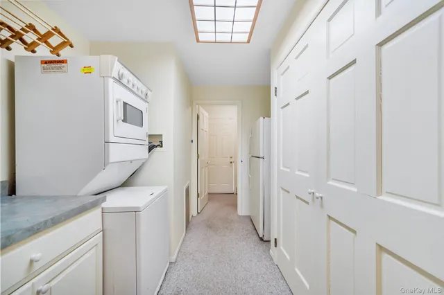 a view of a hallway with a white car parked in a corridor