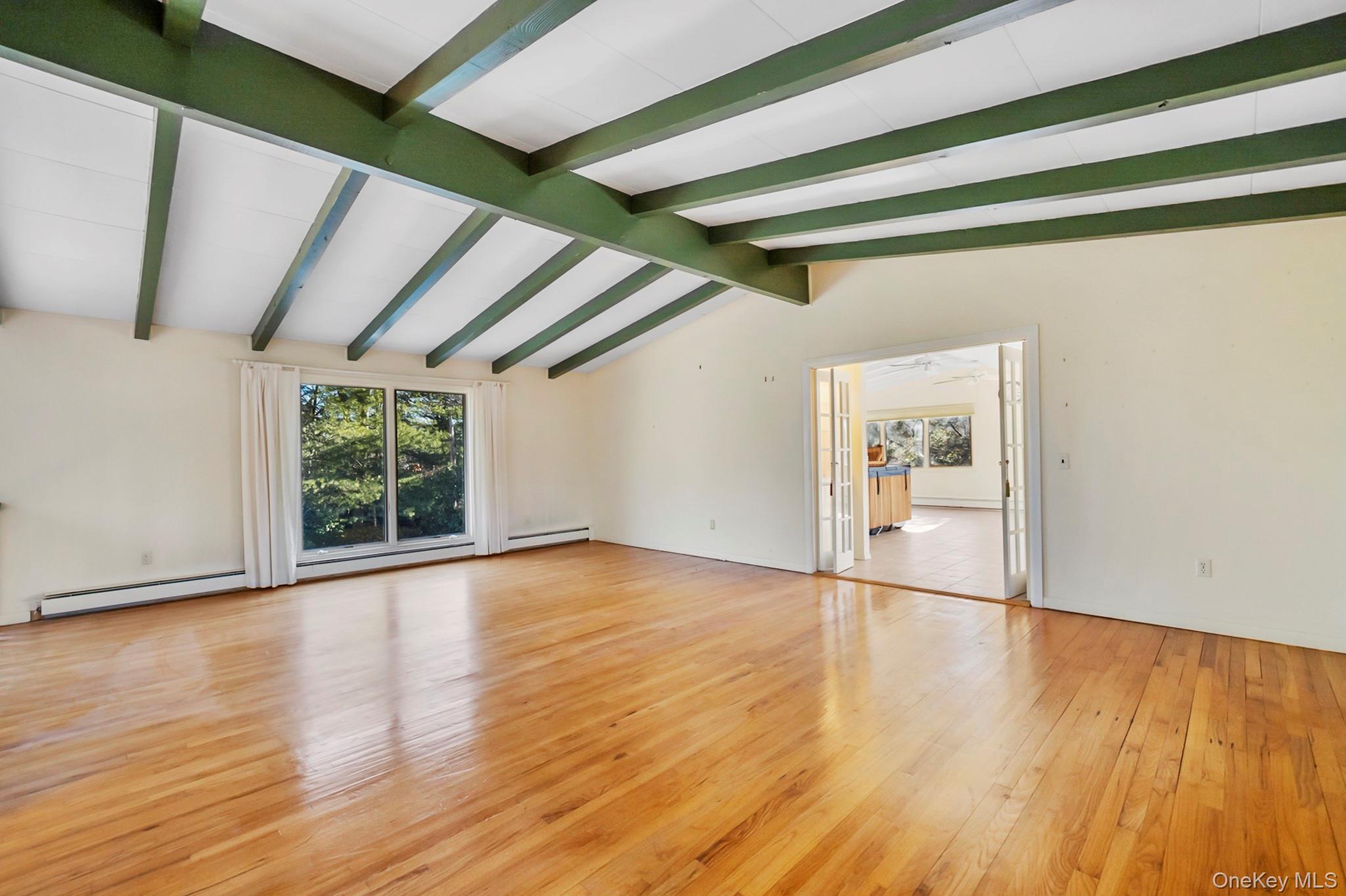149 Munsell Road East Patchogue, NY 11772 - Photo 15 of 29 a view of empty room with wooden floor and fan
