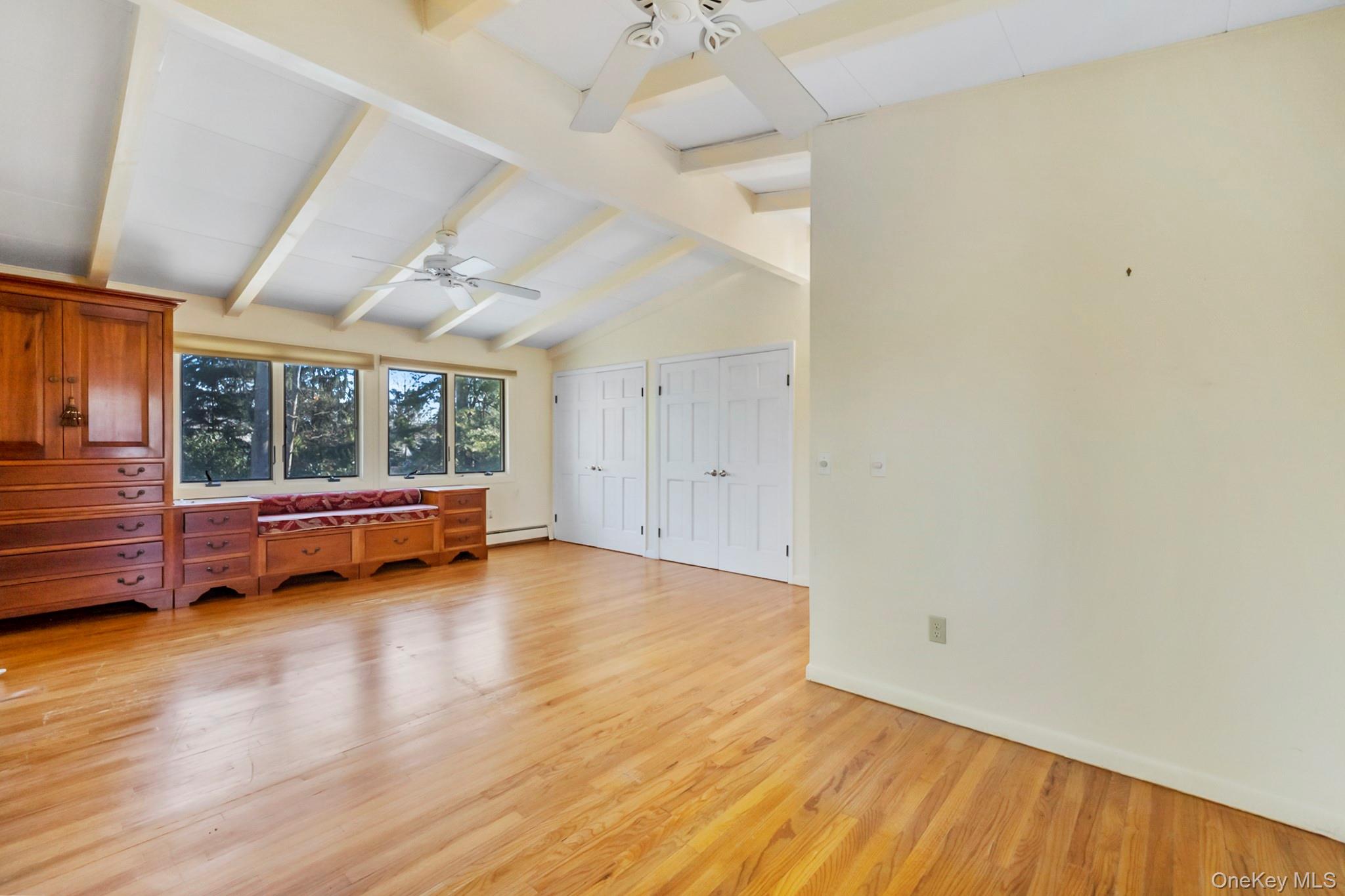 149 Munsell Road East Patchogue, NY 11772 - Photo 20 of 29 an empty room with wooden floor and windows