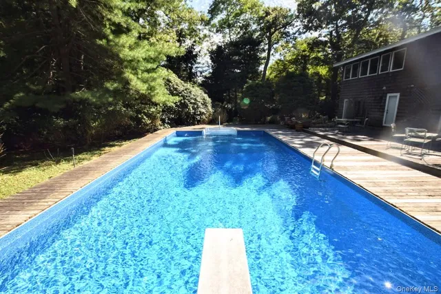 a backyard of a house with yard and trampoline