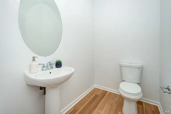 a bathroom with a sink toilet and a mirror