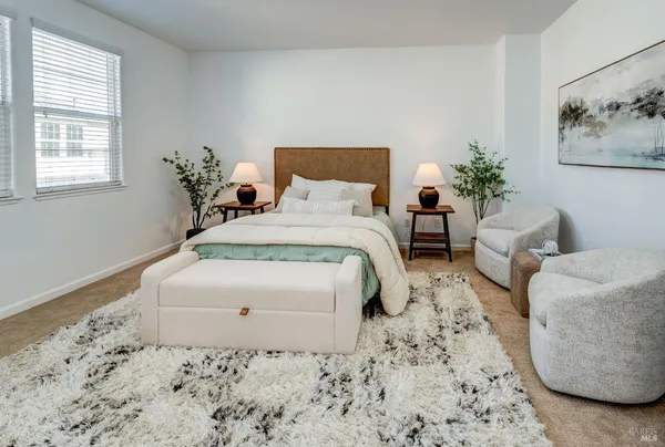 a bedroom with a bed and a couch