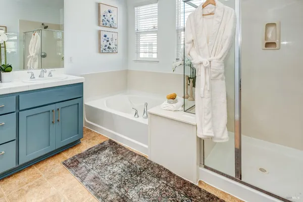 a bathroom with a tub sink and a mirror