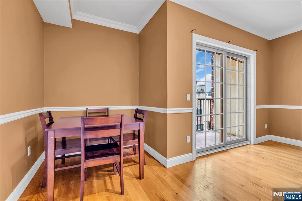 30 Austin Street, Unit 301 Newark, NJ 07114 - Photo 13 of 20 a view of a dining room with furniture and wooden floor