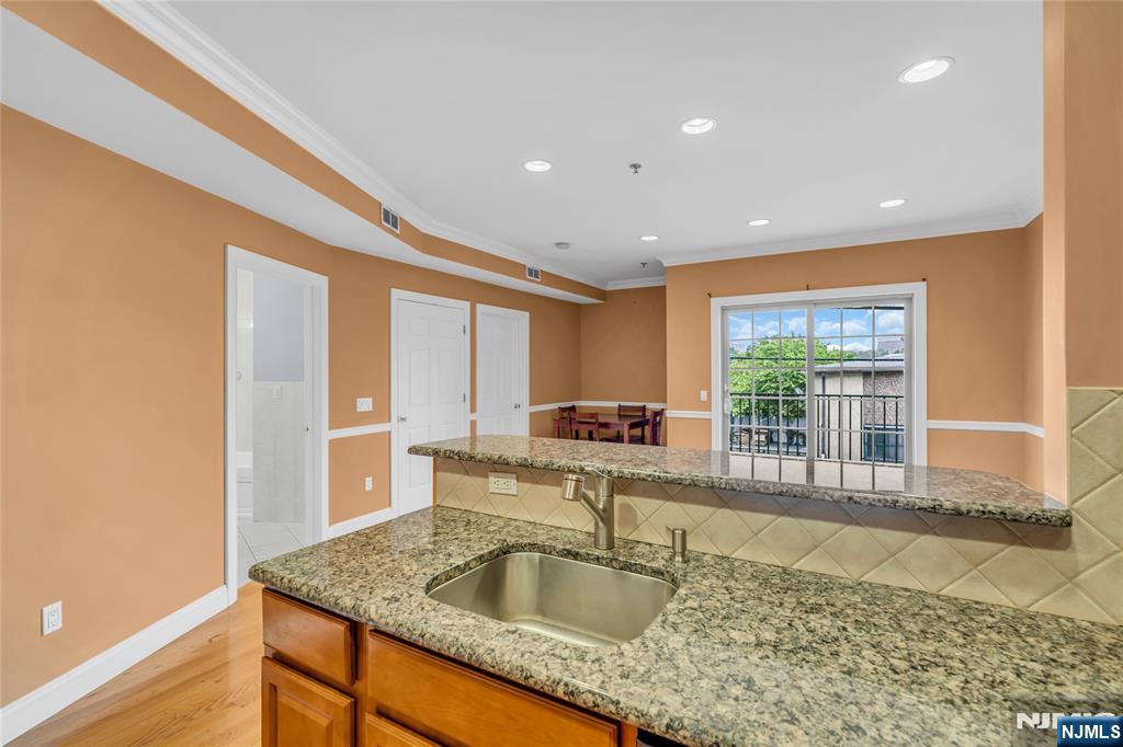 30 Austin Street, Unit 301 Newark, NJ 07114 - Photo 4 of 20 a large kitchen with granite countertop a sink and a large window