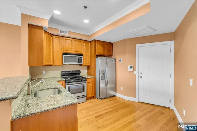 a kitchen with a sink stove and refrigerator