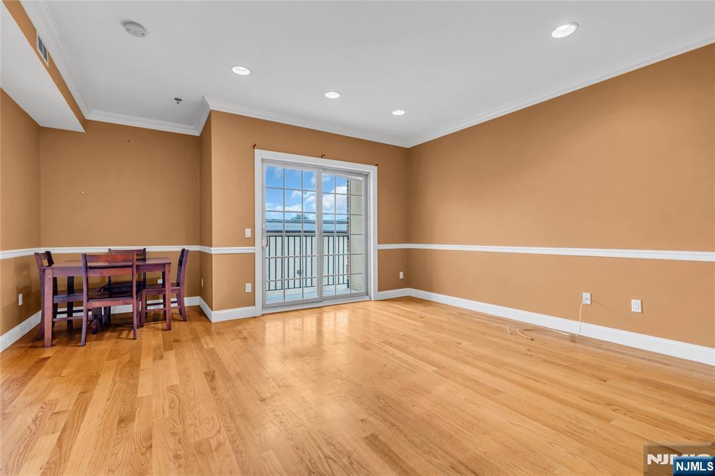 30 Austin Street, Unit 301 Newark, NJ 07114 - Photo 7 of 20 a view of an empty room with wooden floor and a window