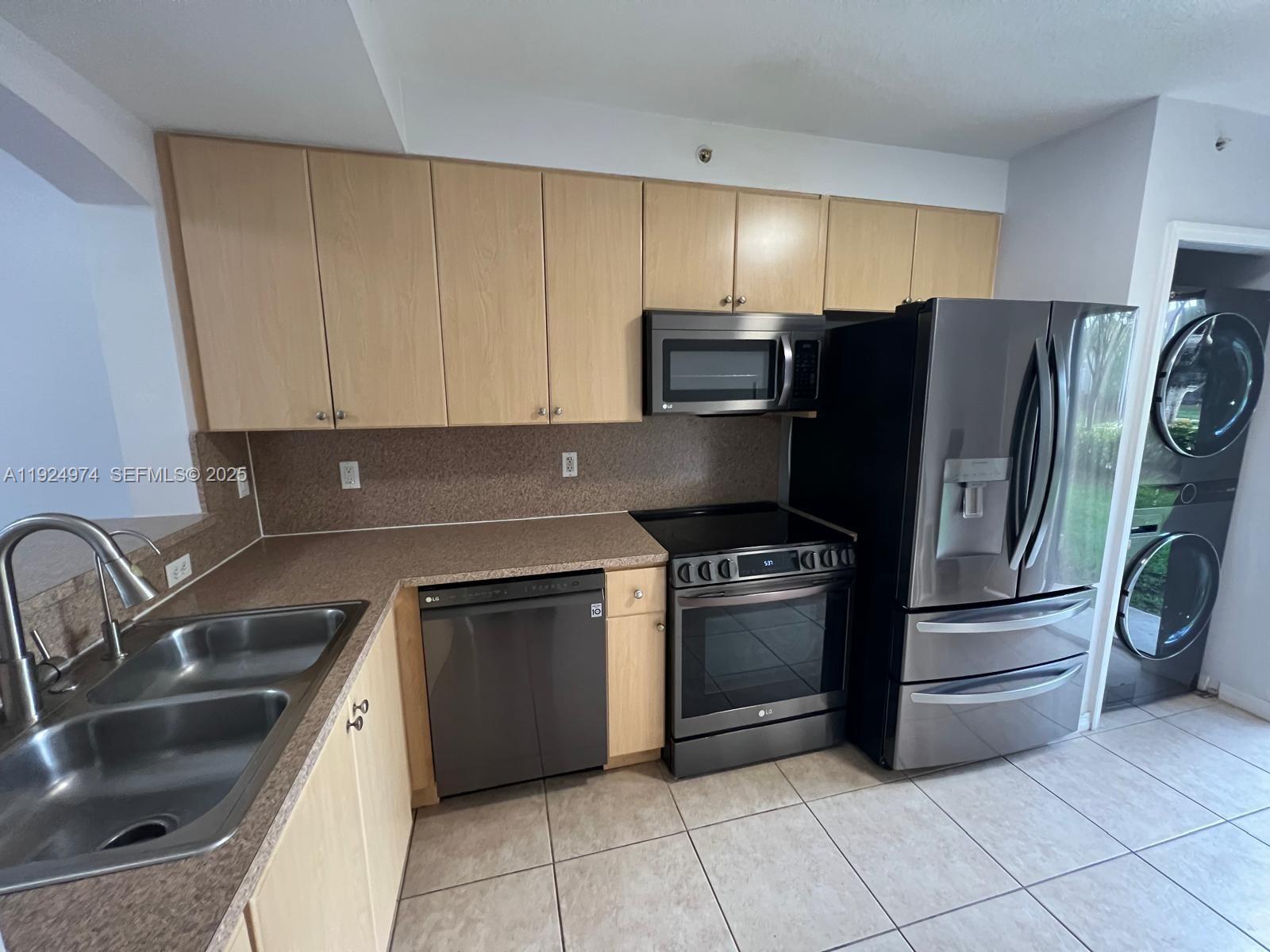 22641 Southwest 88th Place, Unit 103 Cutler Bay, FL 33190 - Photo 1 of 12 a kitchen with stainless steel appliances granite countertop a sink a stove a refrigerator and cabinets