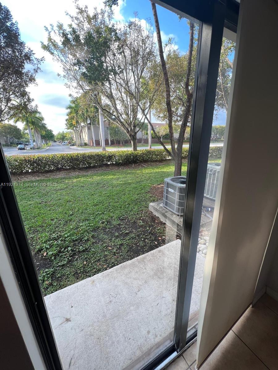 22641 Southwest 88th Place, Unit 103 Cutler Bay, FL 33190 - Photo 12 of 12 a view of a back yard from a window
