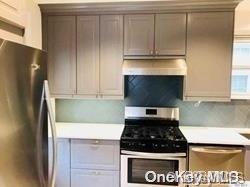 48-15 Clearview Expressway, Unit WHOLE Queens, NY 11364 - Photo 1 of 1 a kitchen with granite countertop a stove and a refrigerator