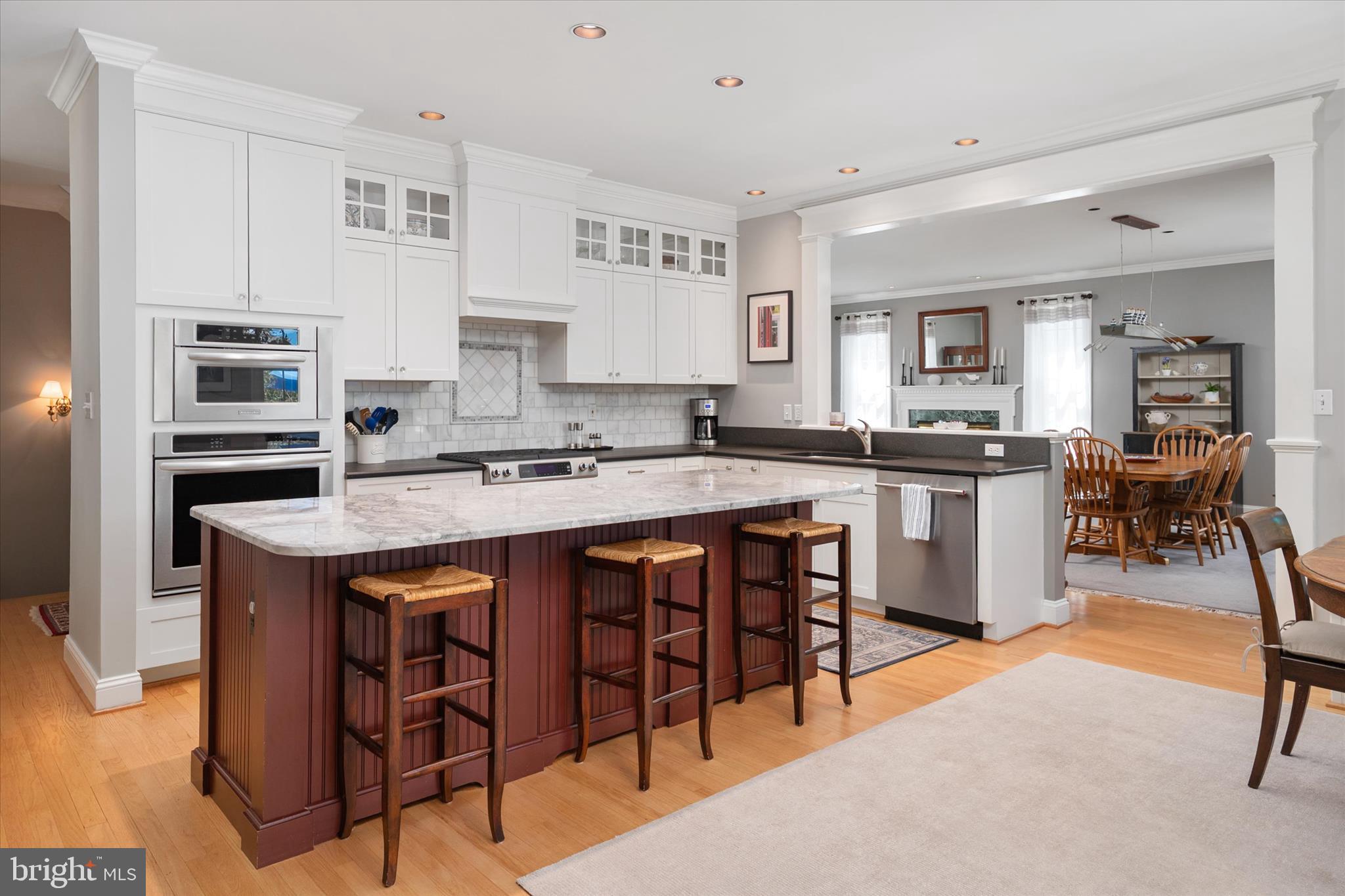 14 Severn River Road Severna Park, MD 21146 - Photo 28 of 73 a kitchen with stainless steel appliances granite countertop a table chairs sink and cabinets