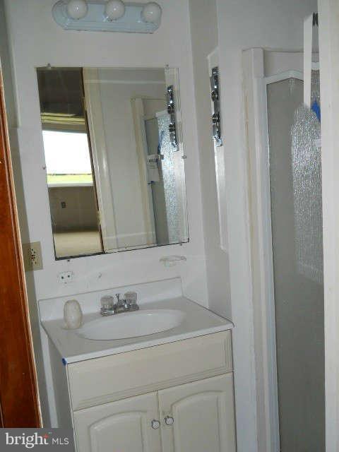 6707 Tweedbrook Road Baltimore, MD 21239 - Photo 16 of 19 a bathroom with a sink and a mirror