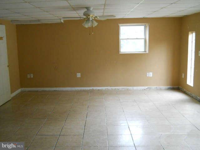 6707 Tweedbrook Road Baltimore, MD 21239 - Photo 17 of 19 a view of an empty room with a window