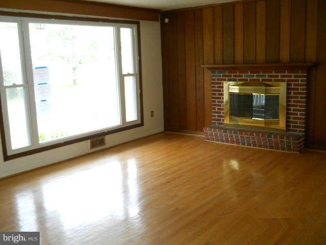 6707 Tweedbrook Road Baltimore, MD 21239 - Photo 4 of 19 a view of an empty room with a fireplace and a window