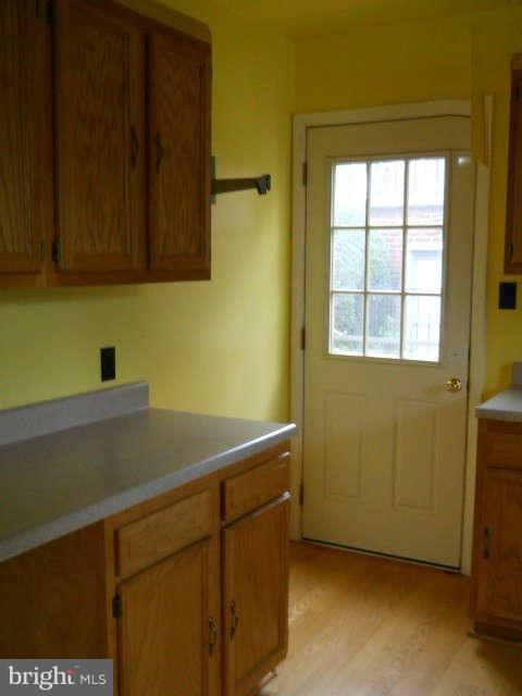 6707 Tweedbrook Road Baltimore, MD 21239 - Photo 8 of 19 a room with a cabinet and a window