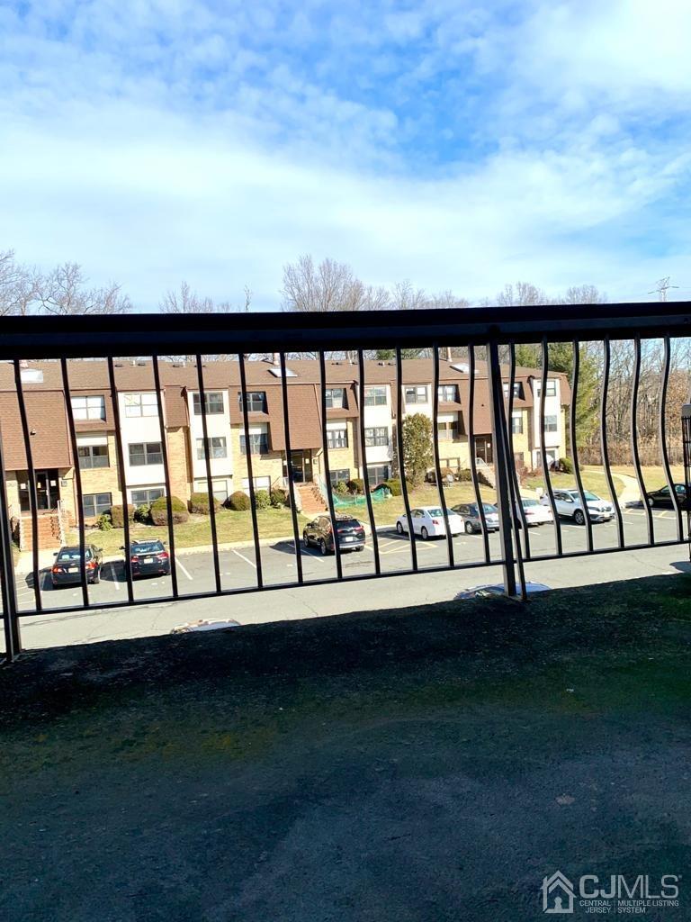 1622 Raspberry Court, Unit 1622 Edison, NJ 08817 - Photo 14 of 17 a view of a big room with wooden floor and fence