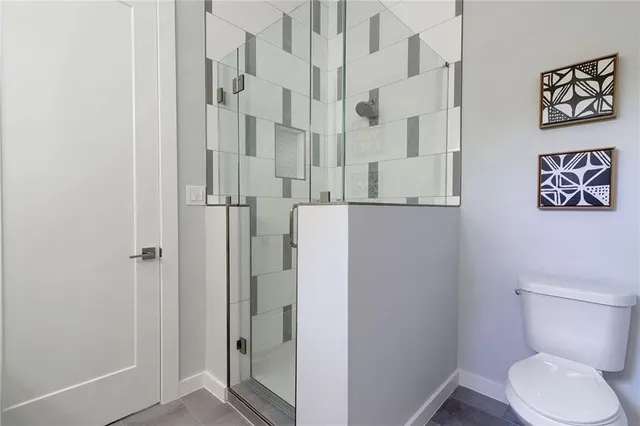 a white toilet sitting next to a bathroom sink