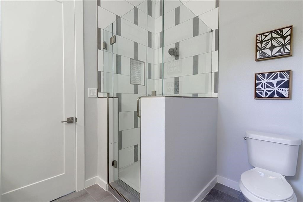 6405 Chesterfield Avenue, Unit A Austin, TX 78752 - Photo 13 of 15 a white toilet sitting next to a bathroom sink