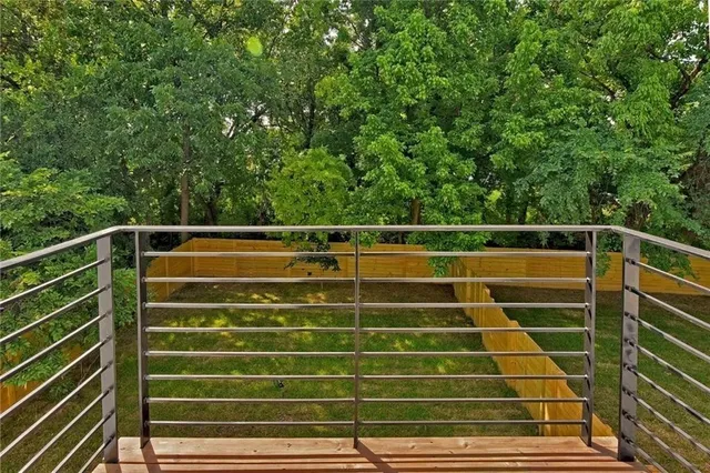 a view of outdoor space with wooden floor and fence