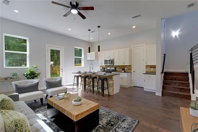 a living room with furniture and wooden floor
