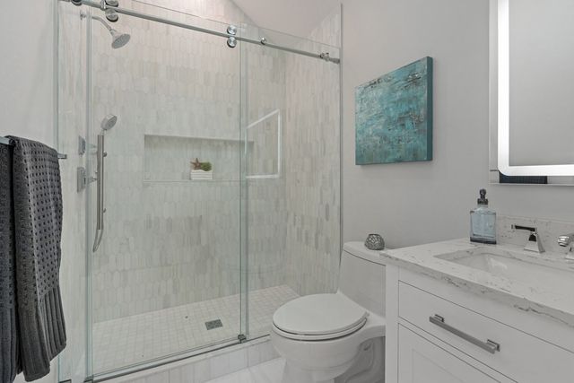 a bathroom with a shower toilet and sink