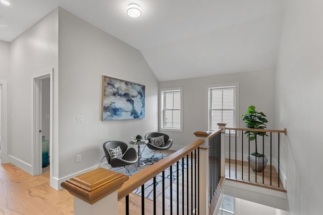 a view of a hallway to a livingroom with furniture