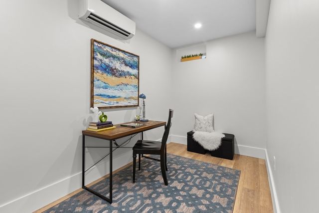 a reading room with furniture and a rug