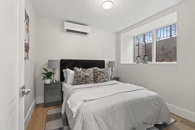 a bedroom with a bed and a window