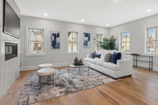 a living room with furniture a rug and a window