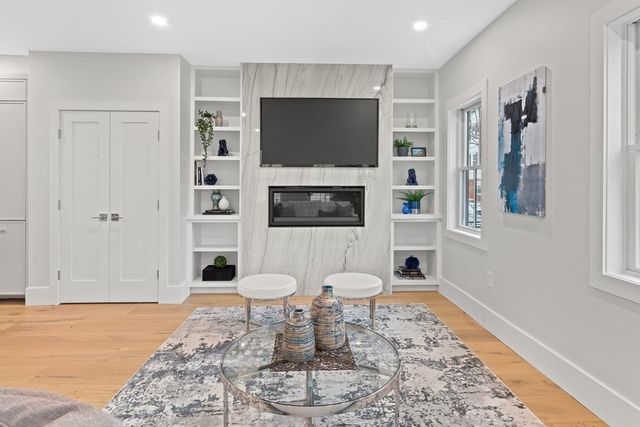 a living room with a flat screen tv and a rug