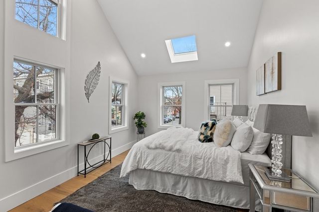 a bedroom with a bed lamps and window