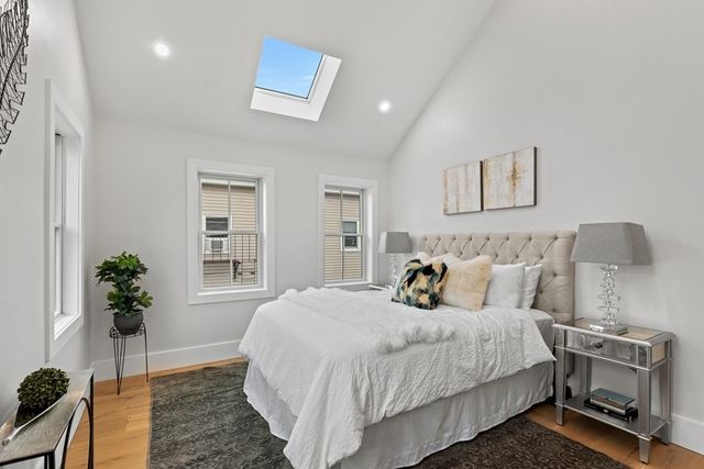 a bedroom with bed and a potted plant