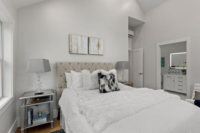 a bedroom with a bed and a tv