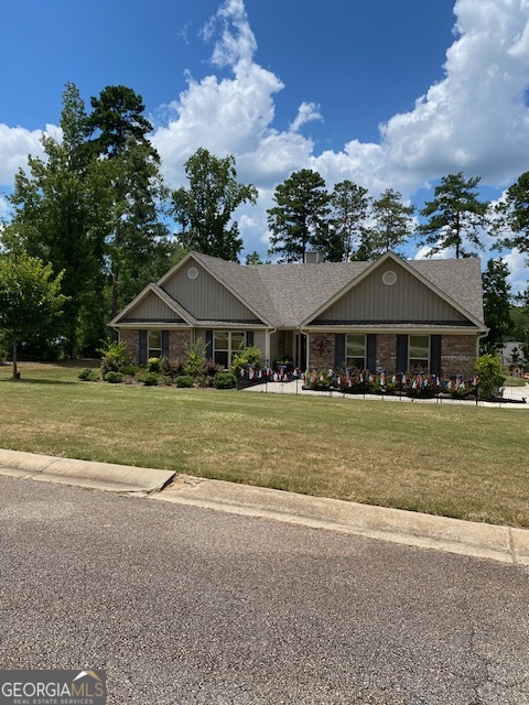 a front view of house with yard and entertaining space