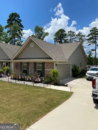 a front view of house with yard and outdoor seating
