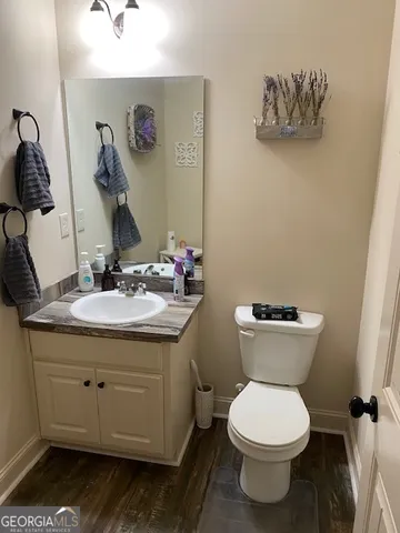 a bathroom with a toilet sink and mirror
