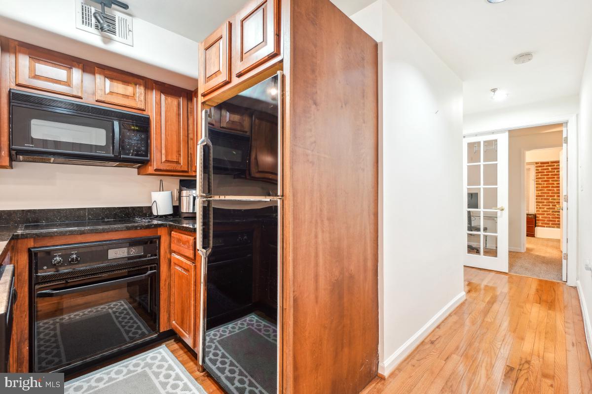 1514 21st Street Northwest, Unit 1 Washington, DC 20036 - Photo 14 of 29 a kitchen view with stainless steel appliances and granite counter tops