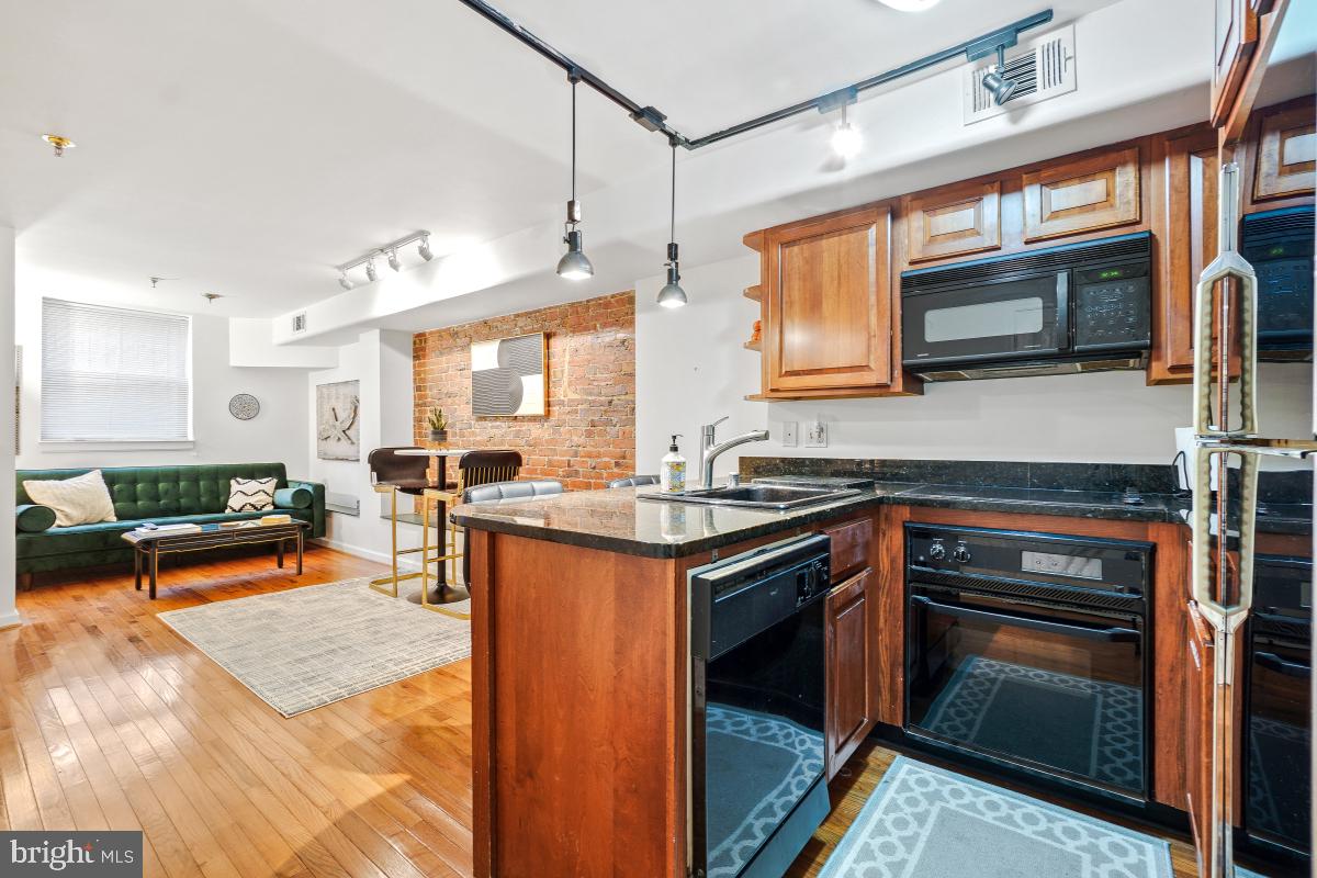 1514 21st Street Northwest, Unit 1 Washington, DC 20036 - Photo 15 of 29 a kitchen with stainless steel appliances granite countertop a stove and a sink