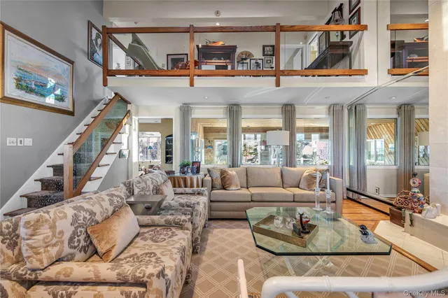 a living room with furniture fireplace and a large window