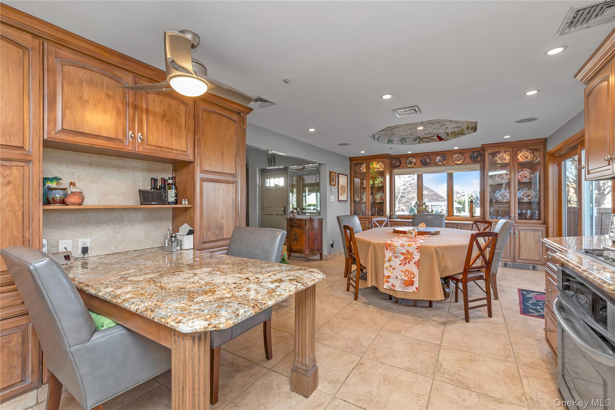 3522 Frederick Street Oceanside, NY 11572 - Photo 9 of 23 Kitchen featuring light stone counters, stainless steel appliances, recessed lighting, tasteful backsplash, and open shelves