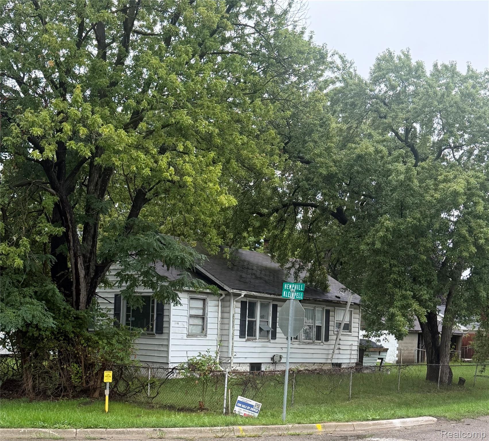 3188 Hemphill Road Burton, MI 48529 - Photo 1 of 1 White siding exterior with dark shutters, corner lot, and mature trees