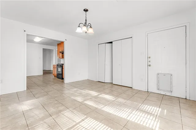 a view of a livingroom with a chandelier and entryway