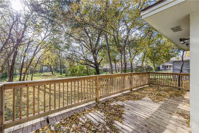 a view of balcony with wooden floor and fence
